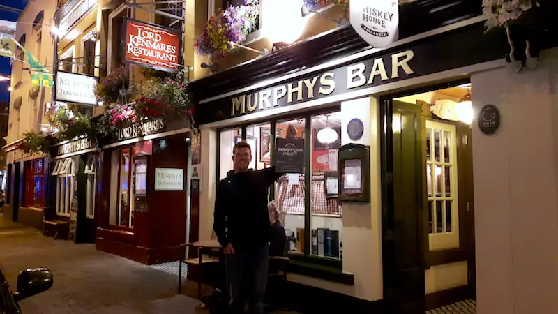 Man outside of an Irish pub called Murphy's Bar in Killarney, Ireland.