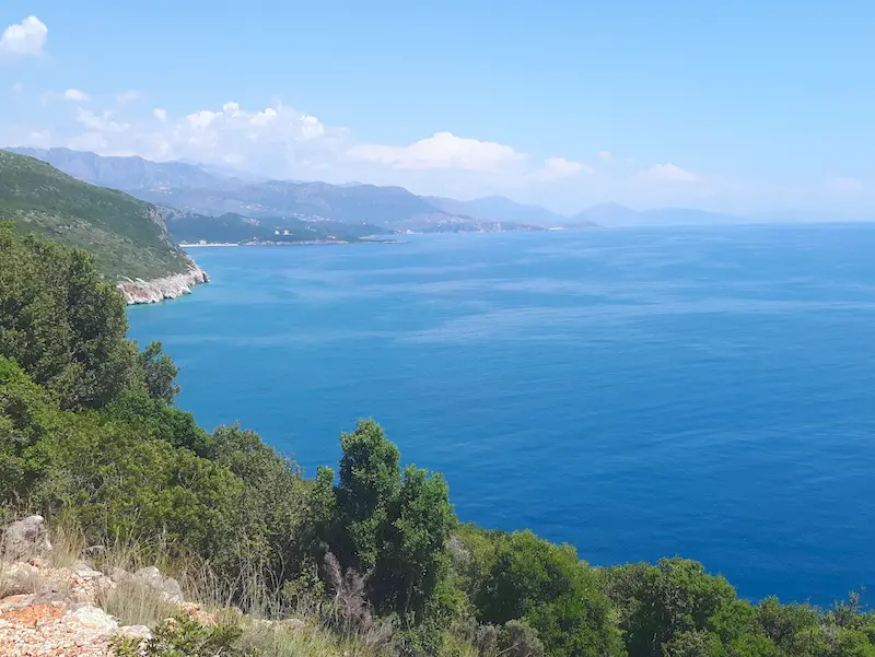 Rugged green coastline with bright blue water on the Albanian Riviera, Albania.