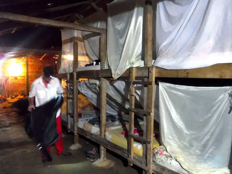 Man getting ready to get into bunkbeds at camp for Lost City Trek, Colombia.