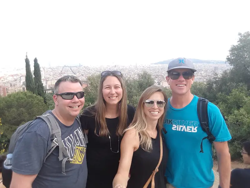 Four friends with a view across Barcelona from El Carmel Bunkers, Spain.