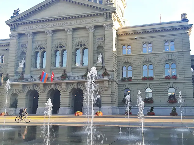 Grand government building with fountains in front in Bern, Switzerland.