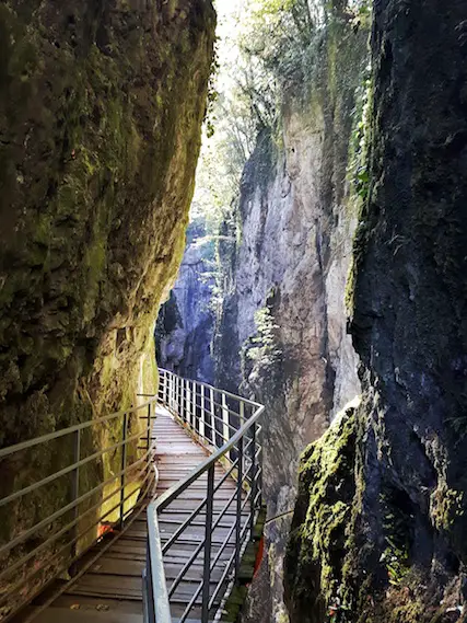 Suspended walkway through a tall, narrow Gorges du Fier, Annecy France.