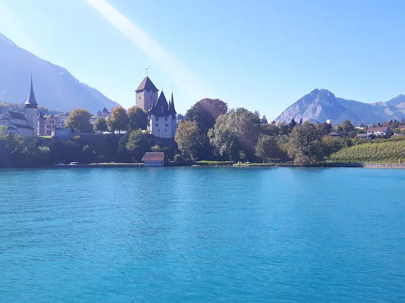 Church and castle in view of Spietz from Lake Thun ferry, Switzerland.