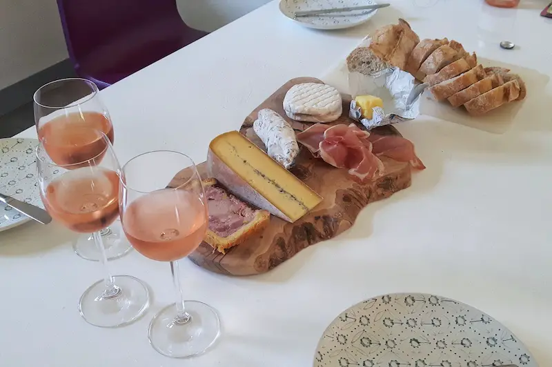 Cheese, meat, bread and wine on a platter for a typical French lunch, France.