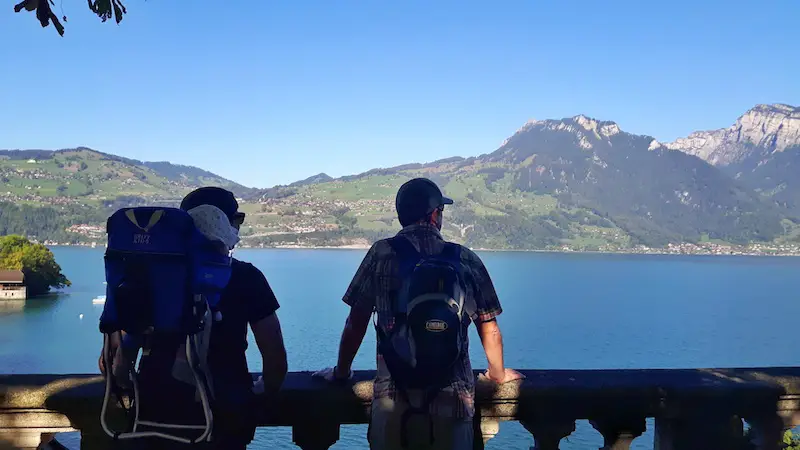 Two men and a baby, view Lake Thun, Switzerland.