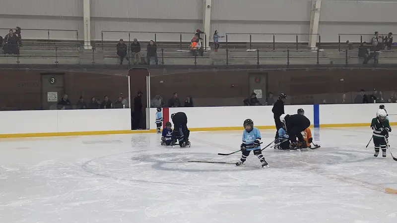 Young children playing hockey in Canada.