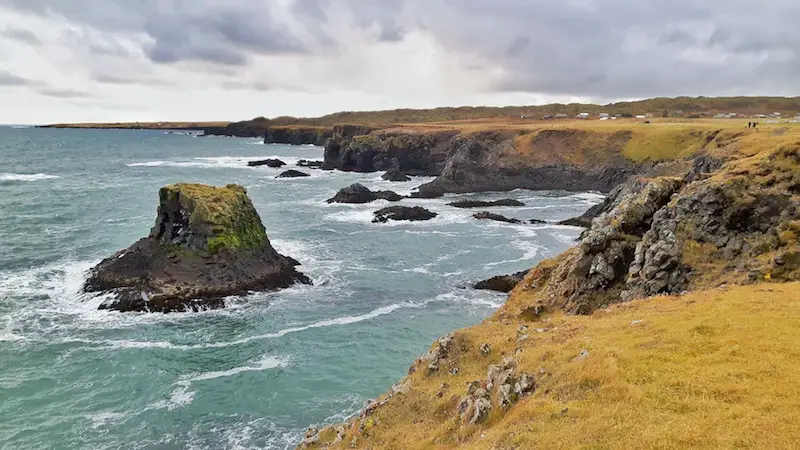 sea cliffs, basalt column in the rough seas off Arnastapi, Iceland