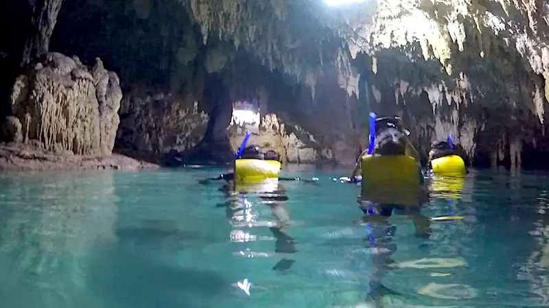 People snorkelling in Cenote Sac Actun, Mexico.