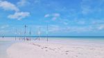 Relaxing in hammocks in water with letters HOLBOX on top in Mexico