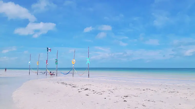 Hammocks in water with letters HOLBOX on top. in Mexico