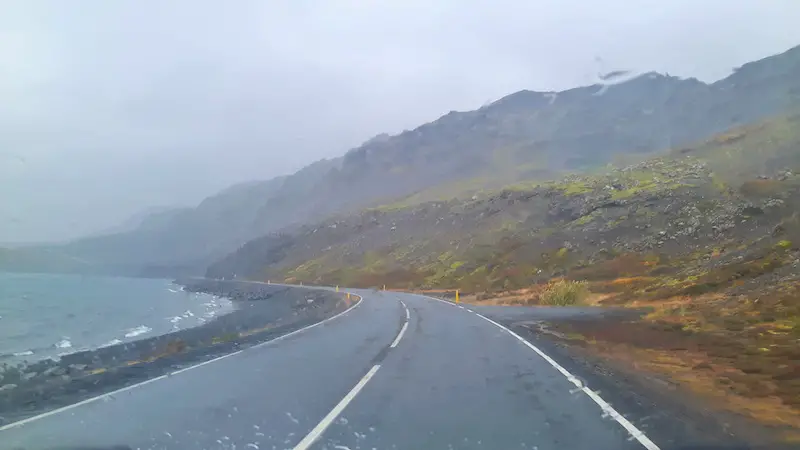 rain and wind while driving along a lake in Iceland