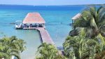 View of blue lake and palapa from our rooftop patio in Laguna Bacalar, Mexico