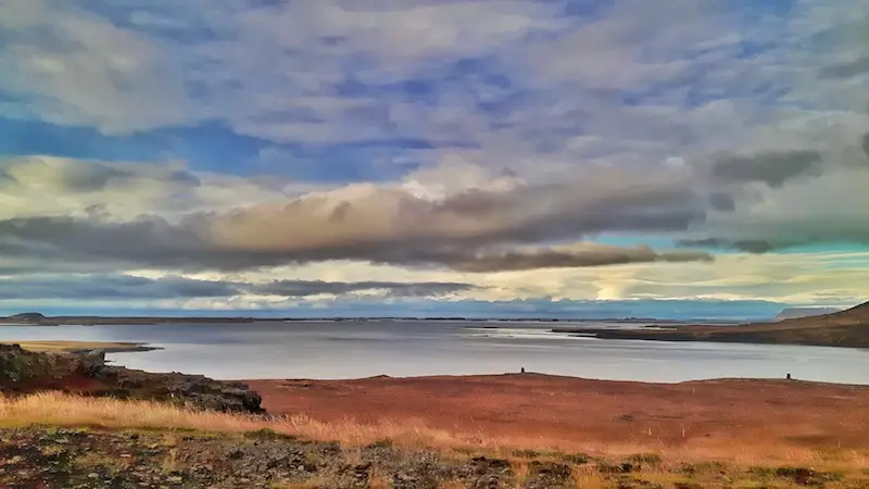 Red grasses, water and rugged coastline along Iceland's west coast