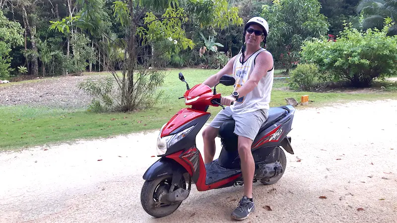 Man on red scooter in Tulum, Mexico