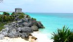 Maya ruins - watchtower on cliff overlooking turquoise Caribbean Sea in Tulum, Mexico