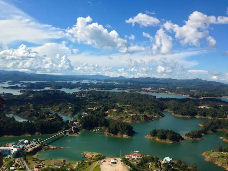 Emerald lake dotted with green islands from above in Guatape, Colombia.