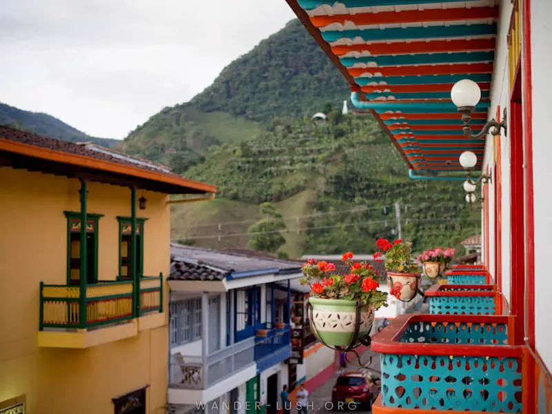 Colourful houses, flower baskets and mountains from a balcony in Jardín, Colombia.