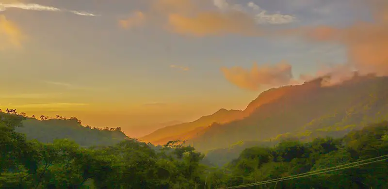 Orange haze over the hills looking out from Minca, Colombia.