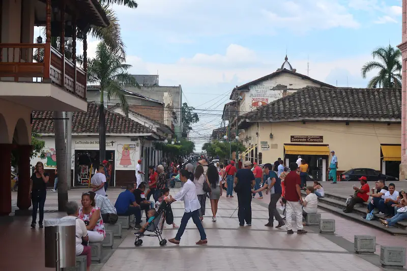 People walking in the street in the town of Buga, Colombia.