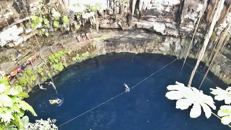 Looking down at deep blue water in Cenote Oxman from high above in Valladolid, Mexico.