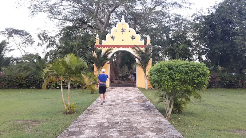 Ornate yellow arch entrance to Hacienda San Lorenzo Oxman, Valladolid Mexico.