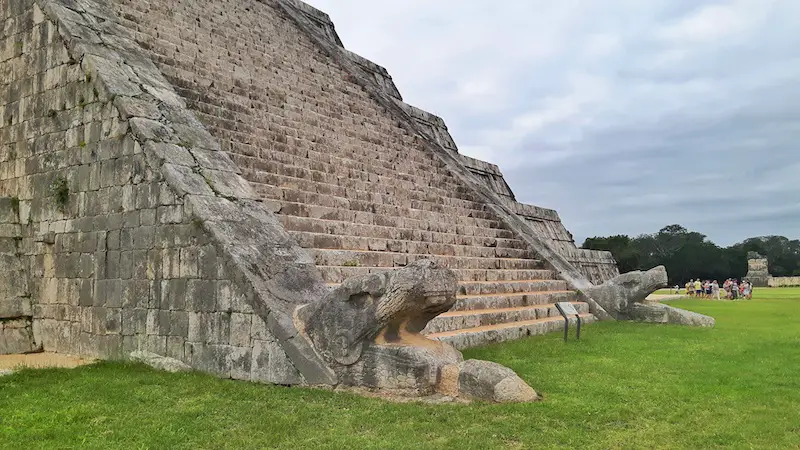 Serpents head at base of pyramid in Chichen Itza Mexico.