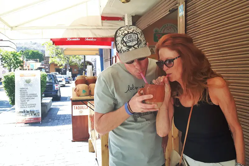 Man and woman sharing a drink in Tequila, Mexico.