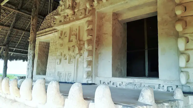 Entrance to a tomb with ornate carvings and giant jaguar teeth on the Acropolis, Ek Balam ruins, Valladolid Mexico.