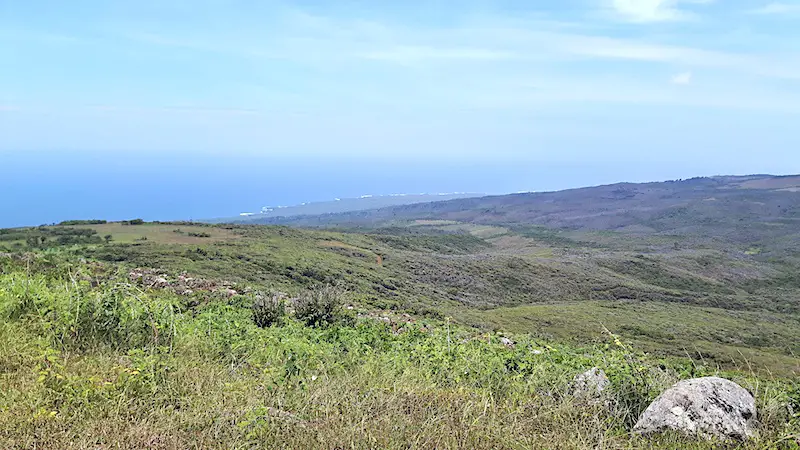 View across green landscapes to Pacific Ocean from El Junco, San Cristobal Galapagos.