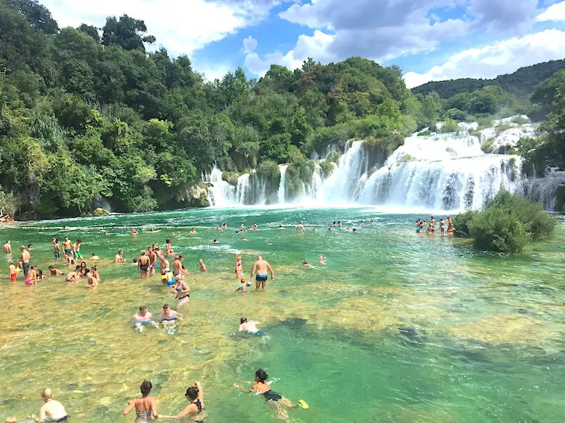 People swimming at the waterfall in Krka National Park, Croatia.