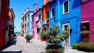 Small square with brightly coloured houses in Venice Italy.