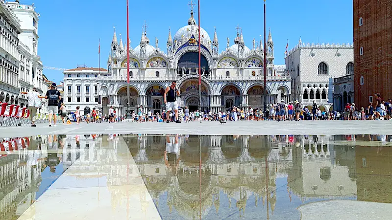 St Mark's Basilica reflected in a puddle in Venice Italy.