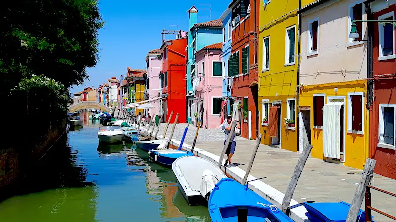 Walking along canal on day trip to Burano, Venice Italy.