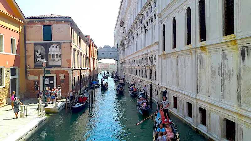 Taking a gondola ride under Bridge of Sighs, Venice Italy.
