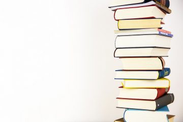 Stack of books with white background to represent teaching and education.