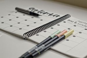 calendar with pens to plan elementary math block