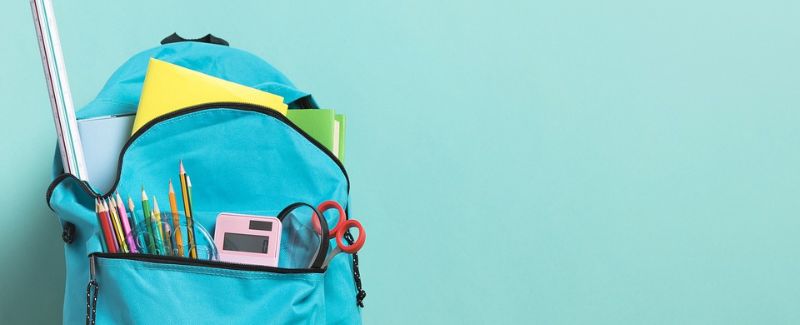 Blue backpack filled with math teaching supplies.